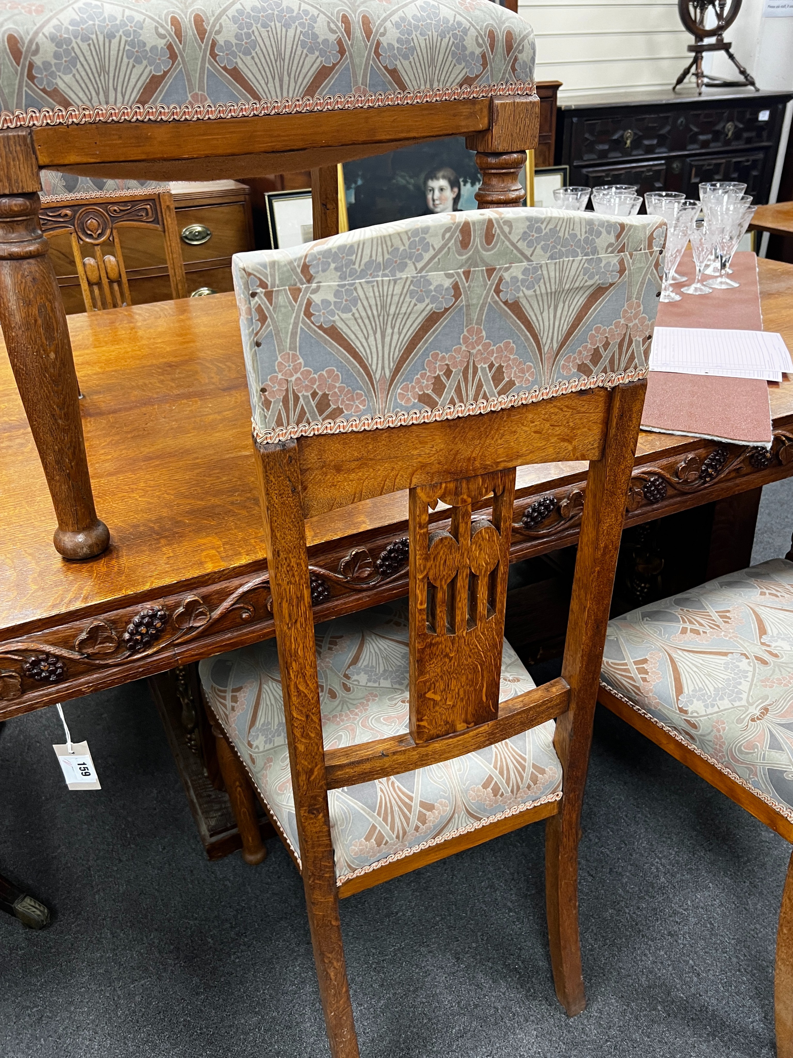 A set of Art Nouveau carved oak dining chairs, one with arms with original Liberty receipt